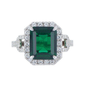 Green emerald with a diamond halo & a pavé band