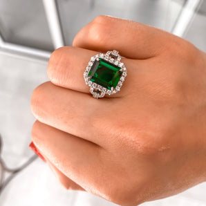 Green emerald with a diamond halo & a pavé band
